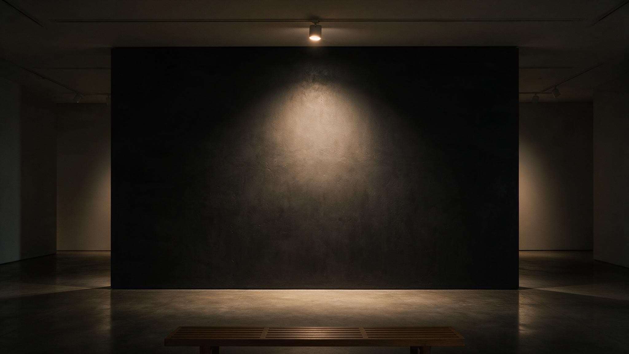A single spotlit map poster of Mumbai on a dark gallery wall